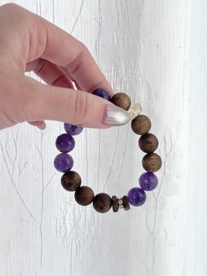 Purple amethyst crystal beads close-up, natural healing bracelet