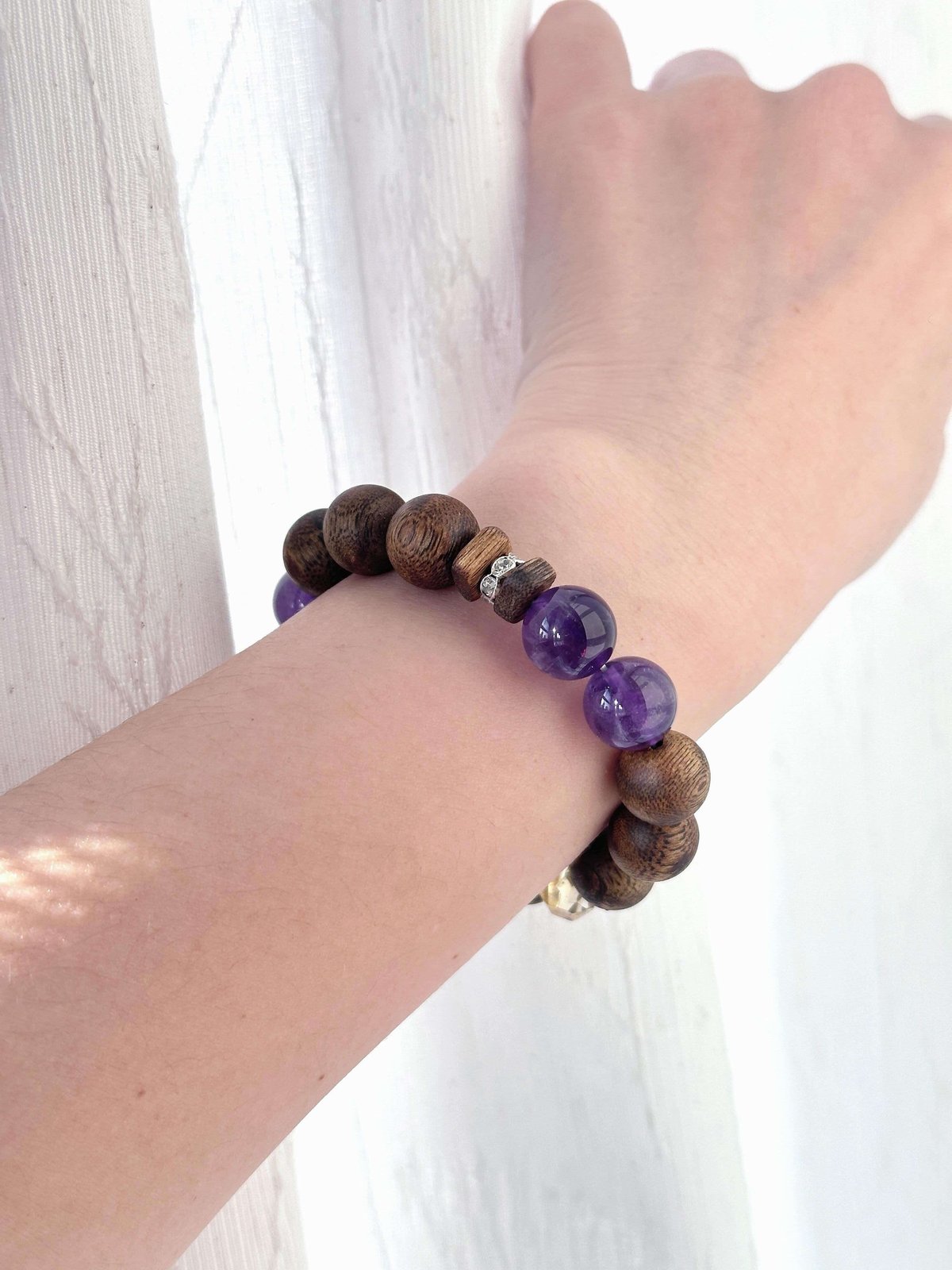 Amethyst bracelet worn on wrist with incense bead