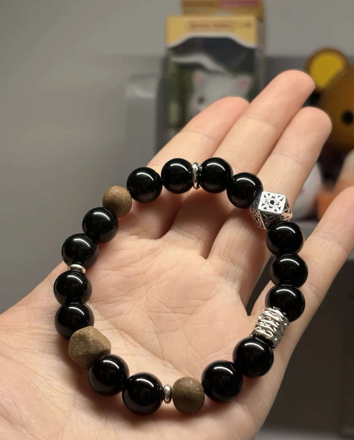 Glossy black obsidian crystal beads close-up
